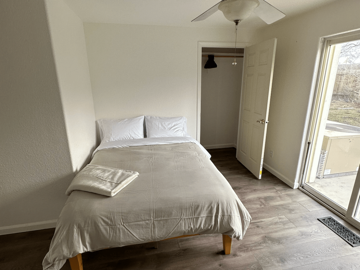 a bedroom with a bed in a room